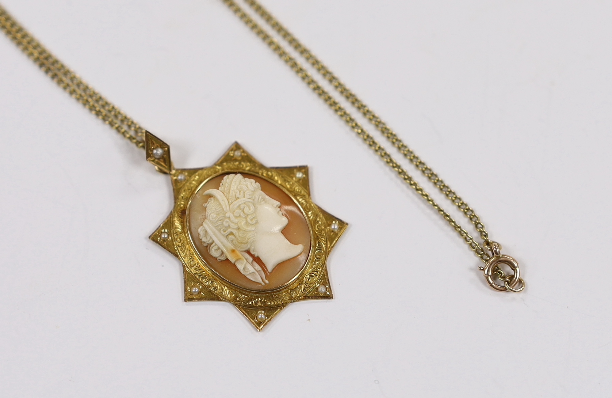 A Victorian yellow metal and seed pearl set cameo shell pendant, 40mm on a 15ct fine link chain, 44cm, gross weight 9.1 grams.